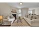 Spacious living room with hardwood floors, fireplace, and neutral-toned furniture at 153 Instructor Ct, Ladson, SC 29456