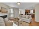 Open living room with hardwood floors, fireplace, and view into the kitchen at 153 Instructor Ct, Ladson, SC 29456