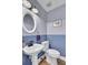 Small bathroom with pedestal sink, toilet, and blue walls at 1661 Battalion Dr, Charleston, SC 29412