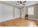 Bedroom with hardwood floors, large closet, and view of living room at 1661 Battalion Dr, Charleston, SC 29412