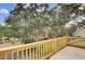 Wooden deck overlooking a lush, tree-filled yard at 1661 Battalion Dr, Charleston, SC 29412