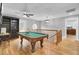 Game room with pool table, built-in shelving and hardwood floors at 1661 Battalion Dr, Charleston, SC 29412