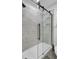 Modern shower with frameless glass doors and marble tile at 1661 Battalion Dr, Charleston, SC 29412