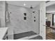 Elegant shower with marble tile, built-in bench, and frameless glass door at 1661 Battalion Dr, Charleston, SC 29412