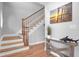 Elegant staircase with wooden railing and hardwood floors at 1661 Battalion Dr, Charleston, SC 29412