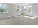 Bright bedroom with carpet, three large windows, and neutral walls at 1892 Grover Rd, Johns Island, SC 29455