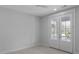 Empty bedroom featuring carpet floors, neutral walls, and french doors to balcony at 1892 Grover Rd, Johns Island, SC 29455