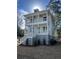 Two-story light gray house with white accents, front porch, and landscaped yard at 1892 Grover Rd, Johns Island, SC 29455