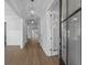 Elegant hallway features wood flooring, white trim, and stylish pendant lighting at 1892 Grover Rd, Johns Island, SC 29455