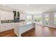 Modern kitchen with white cabinets, island, and hardwood floors at 1892 Grover Rd, Johns Island, SC 29455
