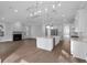 Open concept floor plan with a kitchen island, stainless steel appliances, and a fireplace at 1892 Grover Rd, Johns Island, SC 29455
