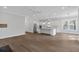 Open-concept kitchen with white cabinetry, stainless steel appliances, and a central island with bar seating at 1892 Grover Rd, Johns Island, SC 29455