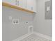 Well-organized laundry room features cabinets, star patterned floor, and utility connections at 1892 Grover Rd, Johns Island, SC 29455