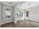 Bright living room with wainscoting, wood floors, and a glass front door at 1892 Grover Rd, Johns Island, SC 29455