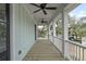 Long porch with outdoor fans and view of backyard and trees at 1892 Grover Rd, Johns Island, SC 29455