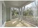 Outdoor space with wooden floor, white railings, and view of backyard and trees at 1892 Grover Rd, Johns Island, SC 29455
