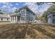Backyard view of a home with blue siding, a screened in porch, and a garage at 1894 Grover Rd, Johns Island, SC 29455