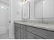 Bathroom with double sinks, grey cabinets, chrome fixtures, and subway tiled shower and bath at 1894 Grover Rd, Johns Island, SC 29455