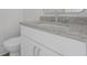 Bathroom vanity with white cabinets, granite counters, chrome fixtures, and nearby toilet at 1894 Grover Rd, Johns Island, SC 29455