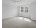 Sun filled bedroom with neutral carpet, white trim, and double hung windows at 1894 Grover Rd, Johns Island, SC 29455