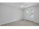 Bright bedroom featuring a ceiling fan, neutral carpet, and doors to a porch at 1894 Grover Rd, Johns Island, SC 29455