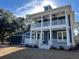 Two-story home with detached garage, wrap-around porch, and large windows at 1894 Grover Rd, Johns Island, SC 29455