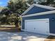 Detached garage with white door and blue siding at 1894 Grover Rd, Johns Island, SC 29455