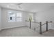 Bright hallway featuring a ceiling fan, neutral carpet, and windows at 1894 Grover Rd, Johns Island, SC 29455