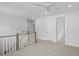 Bright hallway featuring a ceiling fan, neutral carpet, and white doors and trim at 1894 Grover Rd, Johns Island, SC 29455