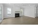 Bright living room features a modern fireplace, neutral paint, light floors, and large windows at 1894 Grover Rd, Johns Island, SC 29455