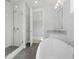 Light filled main bathroom featuring a large tub, shower with glass door and chrome fixtures at 1894 Grover Rd, Johns Island, SC 29455