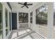 Screened-in porch with a ceiling fan and view to the backyard at 1894 Grover Rd, Johns Island, SC 29455