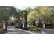 Gated community entrance with lush landscaping and brick pillars at 1908 Basildon Rd, Mount Pleasant, SC 29466