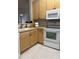 Kitchen with light wood cabinets, white appliances, and tile floor at 1908 Basildon Rd, Mount Pleasant, SC 29466
