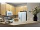 Kitchen with light wood cabinets, white appliances, and breakfast bar at 1908 Basildon Rd, Mount Pleasant, SC 29466