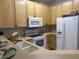 Kitchen boasts light wood cabinets, white appliances and neutral counters at 1908 Basildon Rd, Mount Pleasant, SC 29466