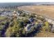 Aerial view of community near water, tennis courts, and mature trees at 2014 Long Bend Dr, Seabrook Island, SC 29455