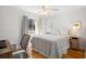 Bright bedroom with a queen-size bed, a workspace, and hardwood floors at 2014 Long Bend Dr, Seabrook Island, SC 29455