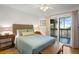 Bright bedroom with private balcony access and ceiling fan at 2014 Long Bend Dr, Seabrook Island, SC 29455