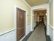 Building hallway with wood door and carpet at 2244 Ashley Crossing Dr # 333, Charleston, SC 29414