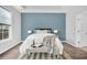 Bedroom with blue accent wall and cozy sitting area at 226 Comiskey Park Cir, Summerville, SC 29485