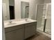Main bathroom with double sinks, gray vanity, and glass shower at 229 Grand View Xing, Summerville, SC 29483