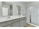 Bathroom featuring a double vanity and enclosed glass shower and mirrors at 229 Grand View Xing, Summerville, SC 29483