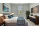 Main bedroom featuring a bed with a decorative blanket, dresser, and mounted television at 229 Grand View Xing, Summerville, SC 29483