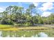House nestled amongst trees near calm water at 26 Cormorant Island Ln, Kiawah Island, SC 29455