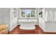 Elegant bathroom with a freestanding tub and hardwood floors at 26 Cormorant Island Ln, Kiawah Island, SC 29455