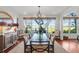 Bright dining room with water views and a rustic wooden table at 26 Cormorant Island Ln, Kiawah Island, SC 29455