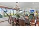Grand dining room with long table, chandelier, and scenic water views at 26 Cormorant Island Ln, Kiawah Island, SC 29455