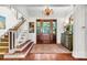 Bright entry featuring hardwood floors, staircase, and a charming console table at 26 Cormorant Island Ln, Kiawah Island, SC 29455