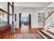 Elegant entry with hardwood floors, staircase, and views to living room at 26 Cormorant Island Ln, Kiawah Island, SC 29455